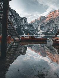 Scenic view of lake by snowcapped mountains against sky