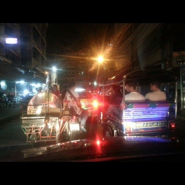 illuminated, night, transportation, land vehicle, car, street, mode of transport, street light, building exterior, city, lighting equipment, built structure, architecture, road, city street, city life, incidental people, outdoors, dark, light - natural phenomenon