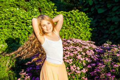 Young woman in front of white flower plants