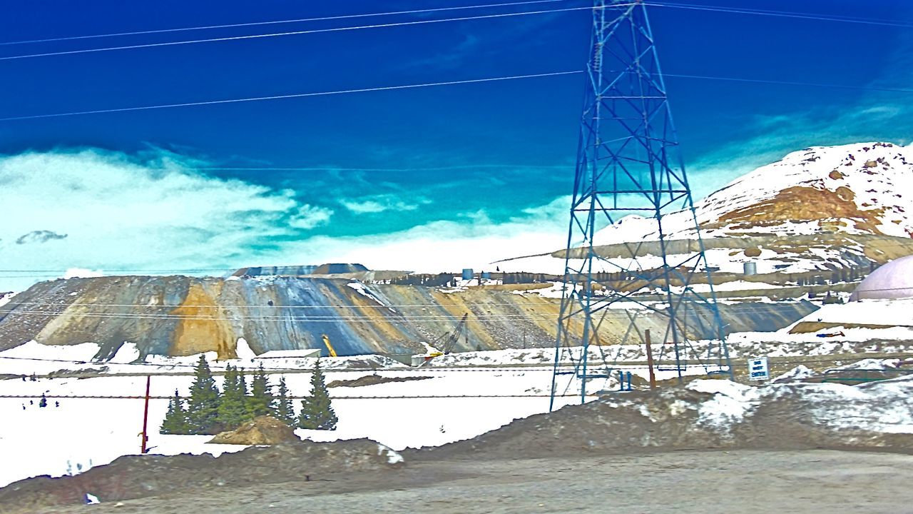 LOW ANGLE VIEW OF POWER LINES AGAINST BLUE SKY