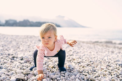 Full length of cute boy on beach