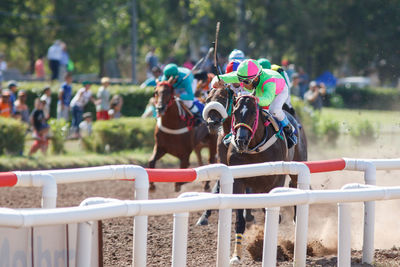 People riding horses during sports race