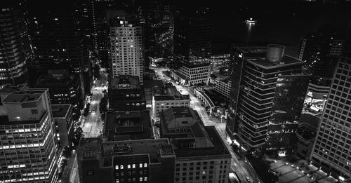 High angle view of illuminated buildings in city at night