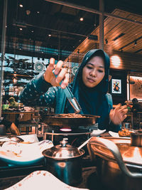 Young woman preparing food in restaurant