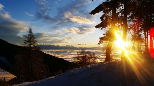 Scenic view of snowy landscape against sky during sunset