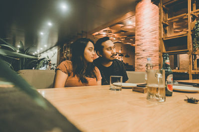 Young woman sitting at restaurant table