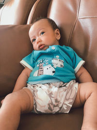 Cute baby girl sitting in car