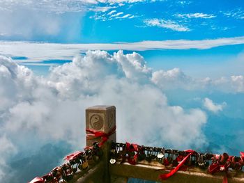 Panoramic view of cross against cloudy sky