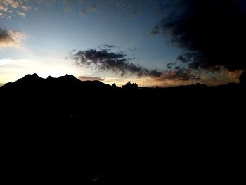 Silhouette landscape against sky during sunset