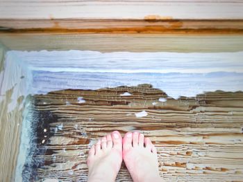 Low section of woman standing on beach
