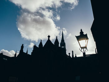 Low angle view of silhouette buildings against sky