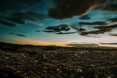 Aerial view of city against dramatic sky