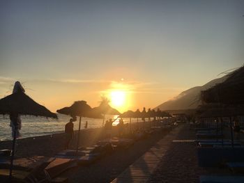 Scenic view of beach against sky during sunset