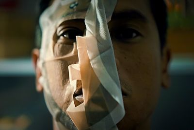 Close-up portrait of man mask covering face