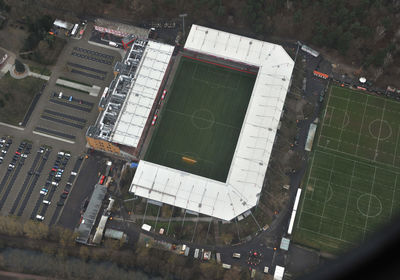 High angle view of soccer field and buildings in city