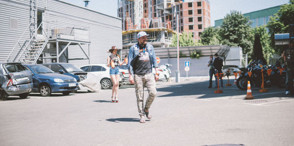 Man with umbrella on street in city