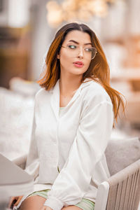 Portrait of young woman using laptop at home