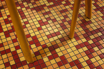 Low section of woman standing on tiled floor