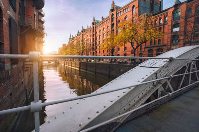 Bridge over canal amidst buildings in city