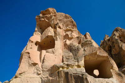 Low angle view of rock formation against blue sky