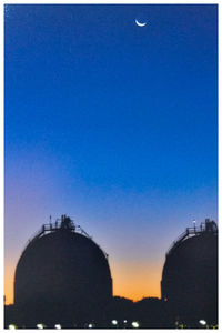 Silhouette of building against blue sky