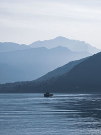 Scenic view of sea and mountains against sky