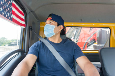 Midsection of man sitting in car