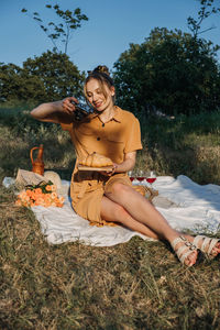 Young woman sitting on field