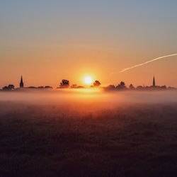 Scenic view of field against sky during sunset