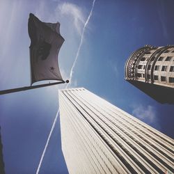 Low angle view of skyscrapers against blue sky