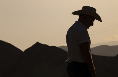 Silhouette of adult man in cowboy hat in desert during sunset. almeria, spain