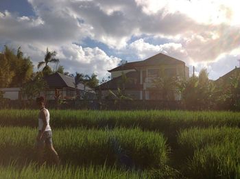 Built structure on grassy field against cloudy sky