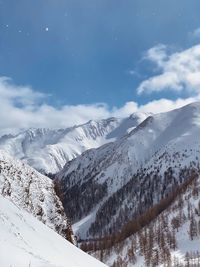 Scenic view of snowcapped mountains against sky