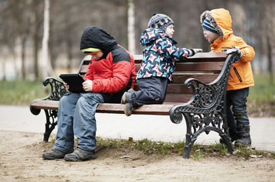 Full length of brothers at park during winter