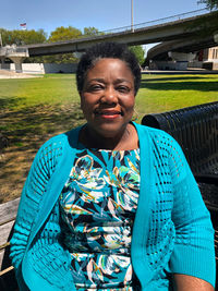 Portrait of smiling woman sitting outdoors