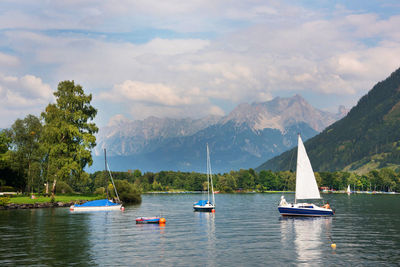 Boats moored in lake against sky