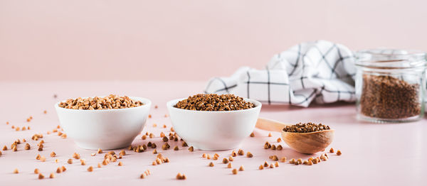 Dry buckwheat tea granules in a bowl, spoon and jar on the table web banner