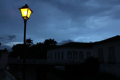 Low angle view of illuminated street light against sky