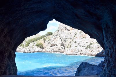 Scenic view of sea seen through cave