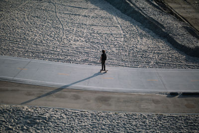 High angle view of man walking on street