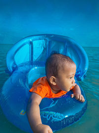 High angle view of boy swimming in pool