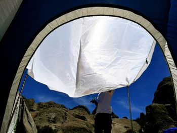 Low section of woman against sky