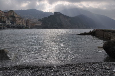 Scenic view of sea and buildings against sky