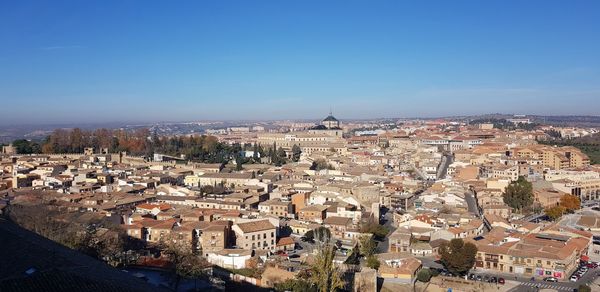 High angle view of townscape against clear blue sky