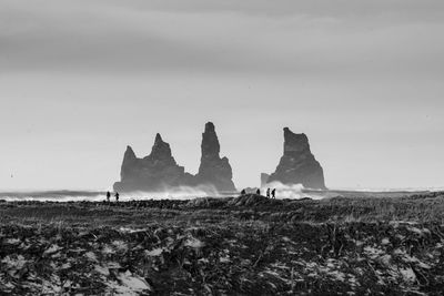 Rock formations on field against sky