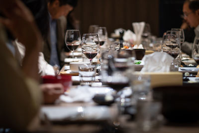 Wine glasses on the table in a fine restaurant at night with company