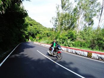 Man riding motorcycle on road