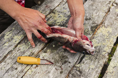 Woman preparing fish after fishing