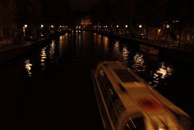 View of bridge over calm river at night