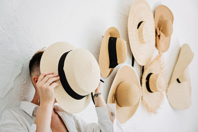 Home decor and interior design. straw hats like interior decorate the walls in apartment